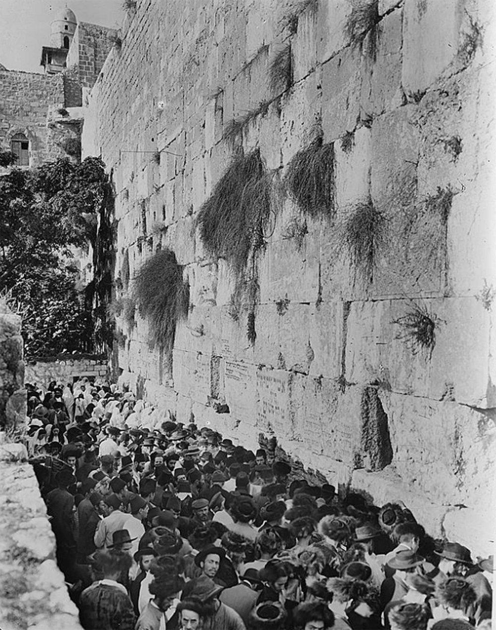 Jewish worshippers crowded in the narrow space between the Western (al-Buraq) Wall and the edge of the Moroccan Quarter, 1920