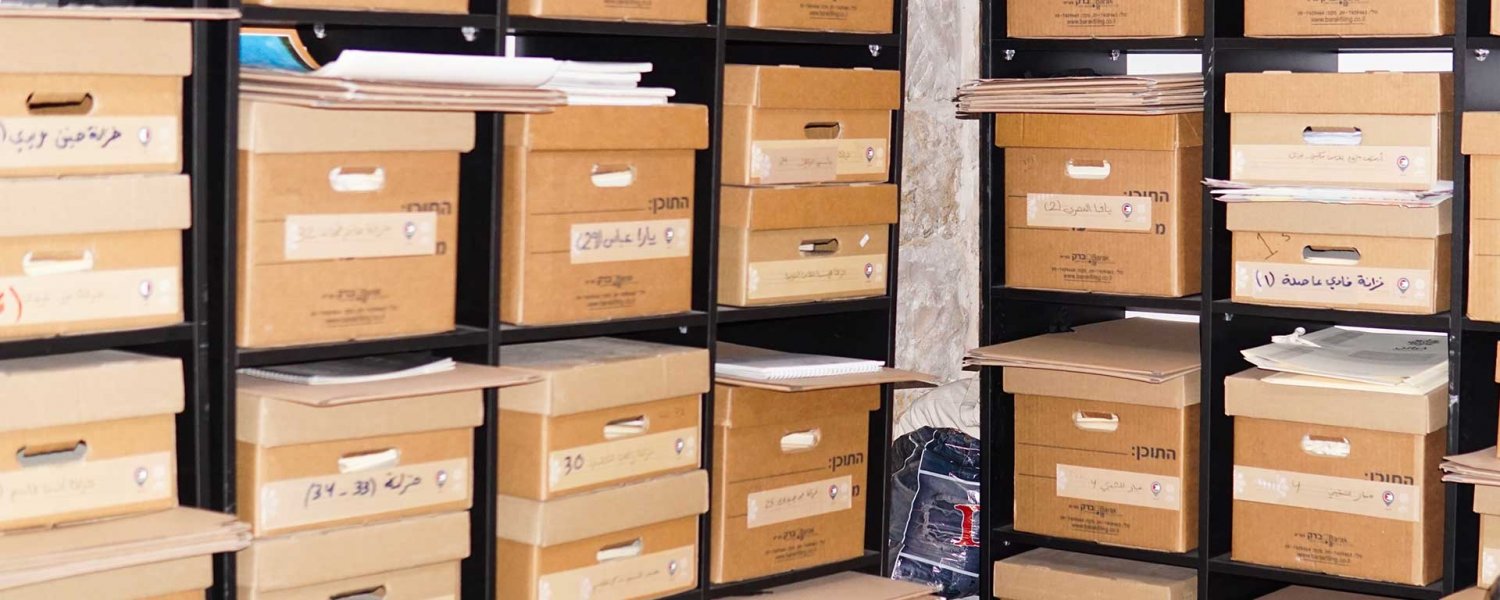 Stacked and labeled boxes filled with artifacts, the filing system of the Khazaaen archive