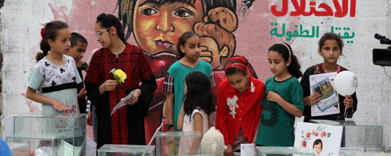 Children in Deir al-Balah mural demolished house