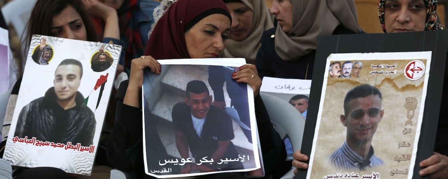 Palestinian women hold portraits of relatives in Israeli jails in support of a hunger strike by detainees, May 25, 2017.