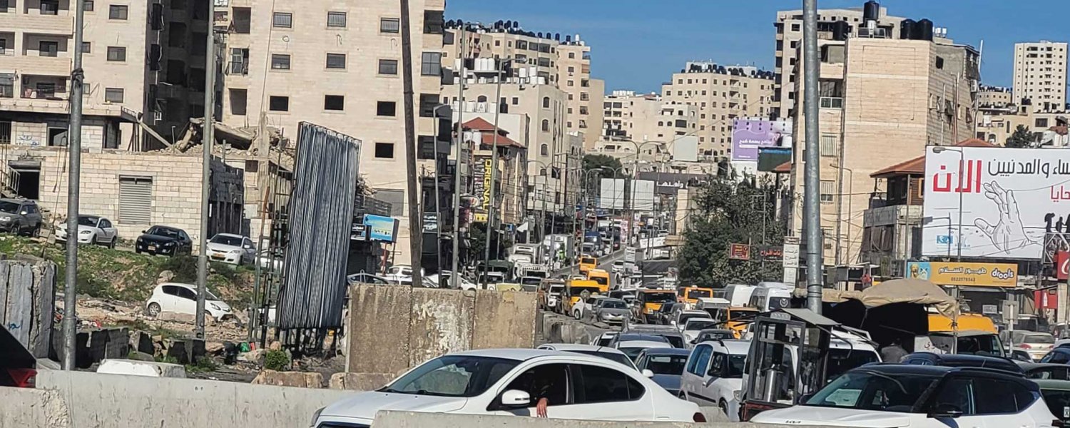 A long line of backed-up traffic waits at Qalandiya checkpoint, December 20, 2023.