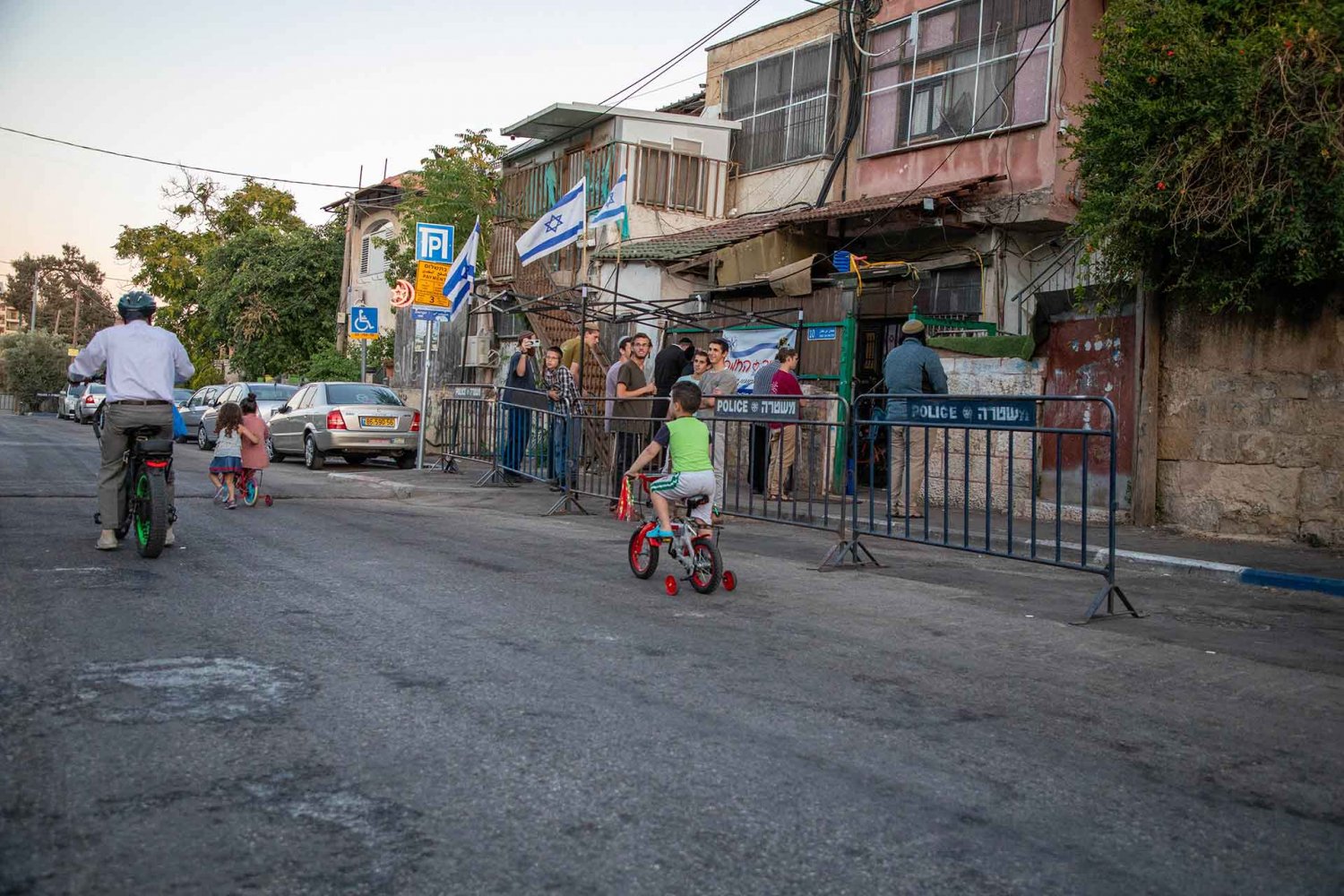 Jewish settlers stand in front of Palestinian houses they occupied in Jerusalem’s Sheikh Jarrah neighborhood, June 10, 2021.