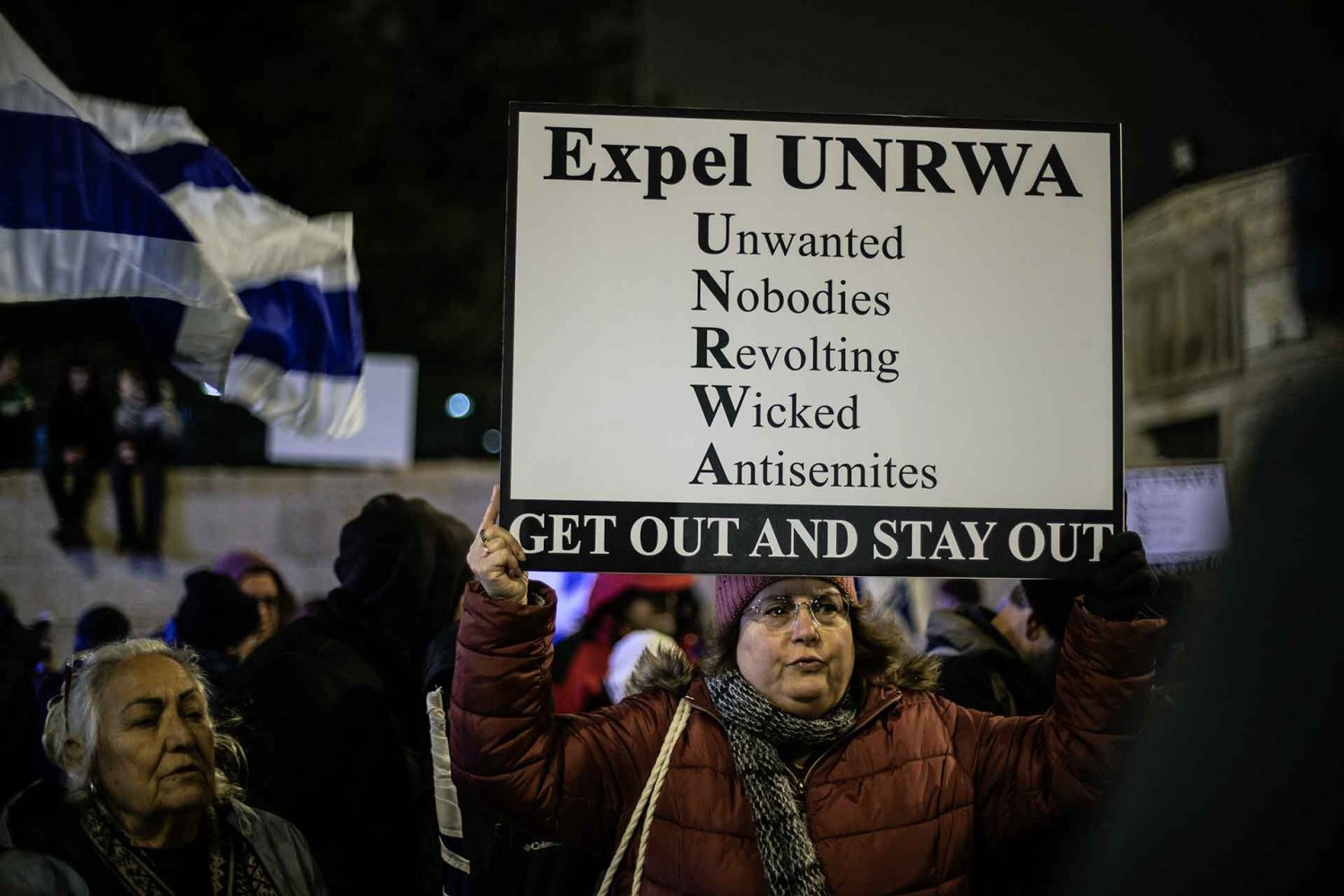 Israeli protesters hold signs outside UNRWA headquarters in Jerusalem demanding its expulsion, February 5, 2024