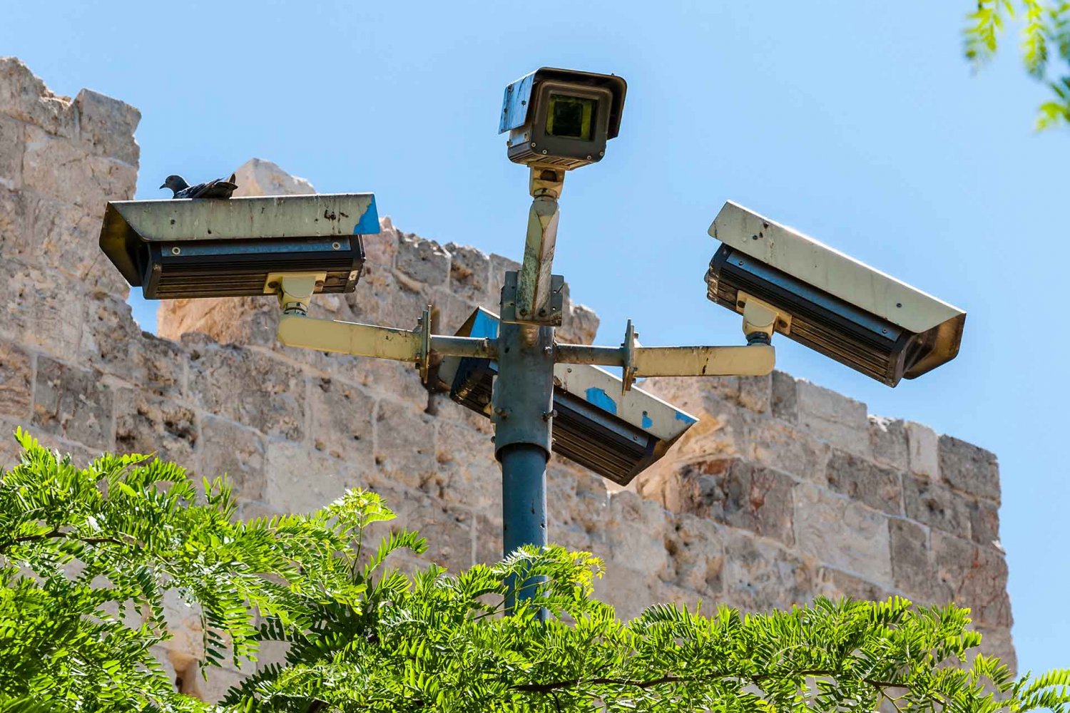 Four surveillance cameras overlook the ancient wall of Jerusalem’s Old City.