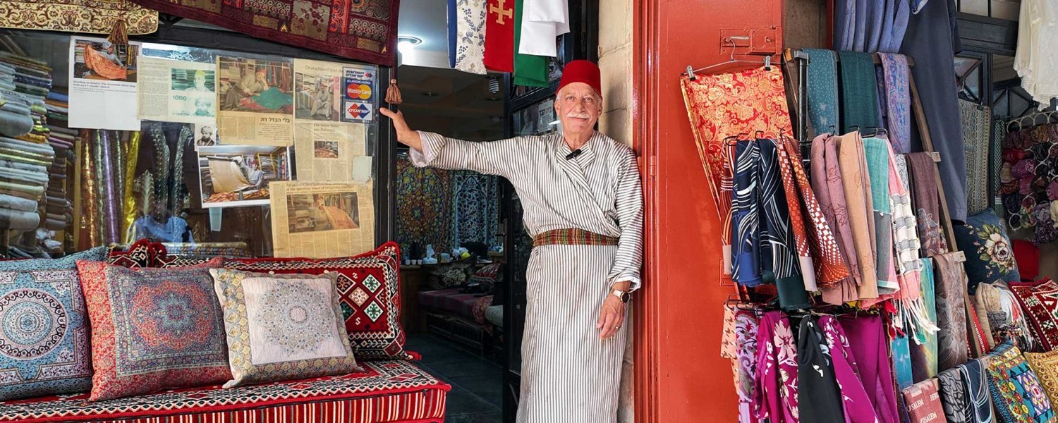 Bilal Abu Khalaf stands outside his fabric shop in Jerusalem’s Old City, July 22, 2024.