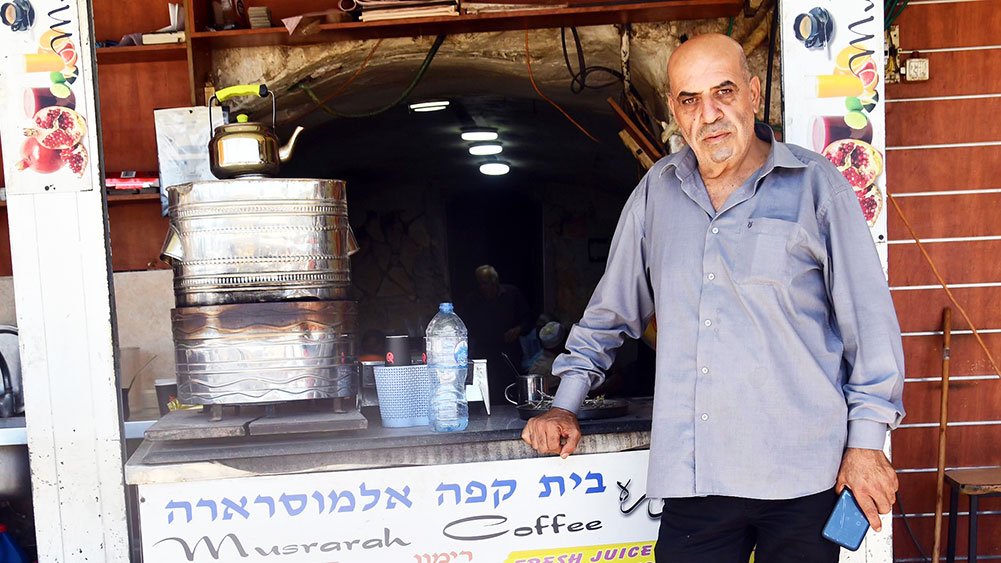 Manager of Musrara Café in Jerusalem stands at the entrance, August 15, 2024.