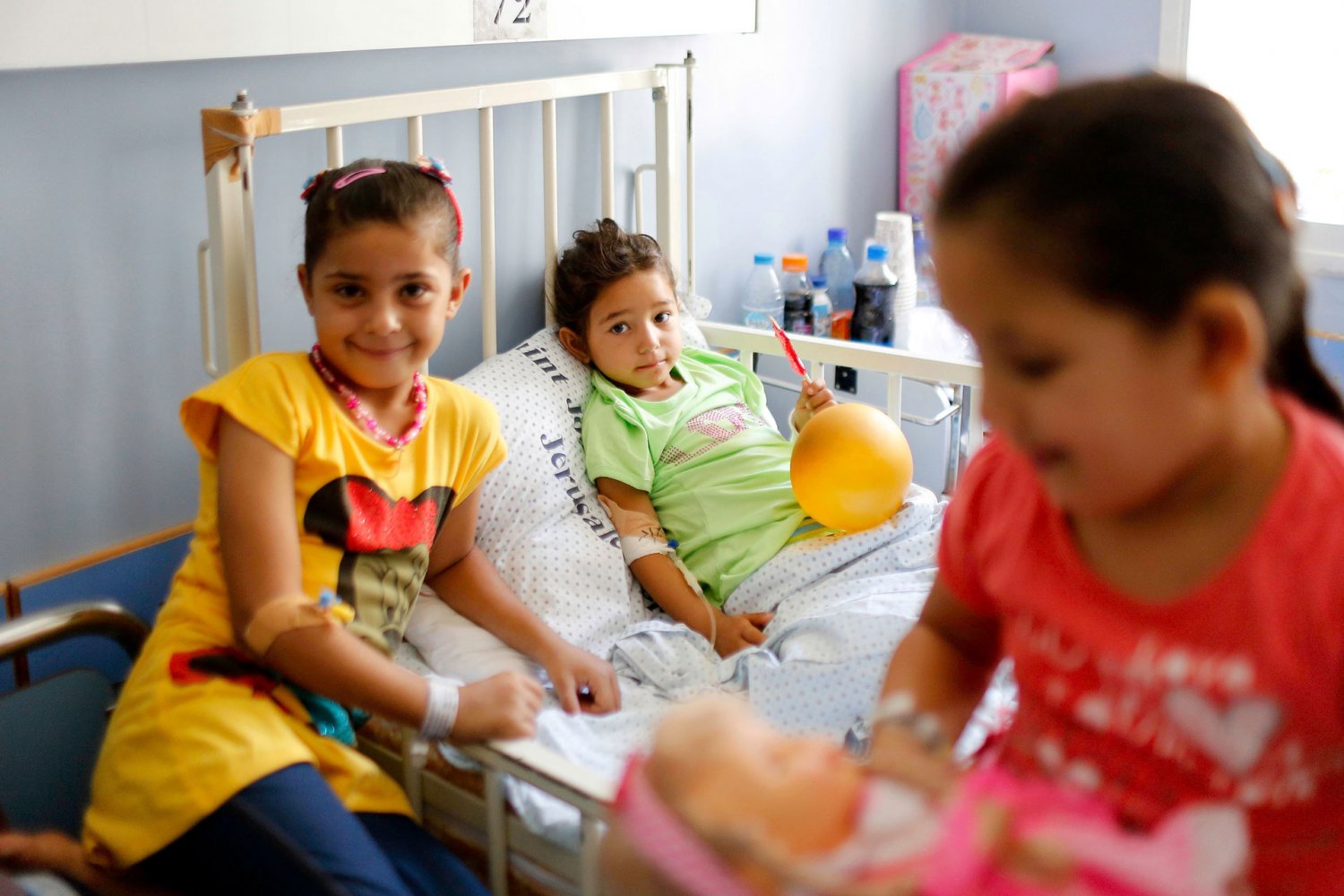 Two girls visit a patient in a hospital in Sheikh Jarrah, East Jerusalem