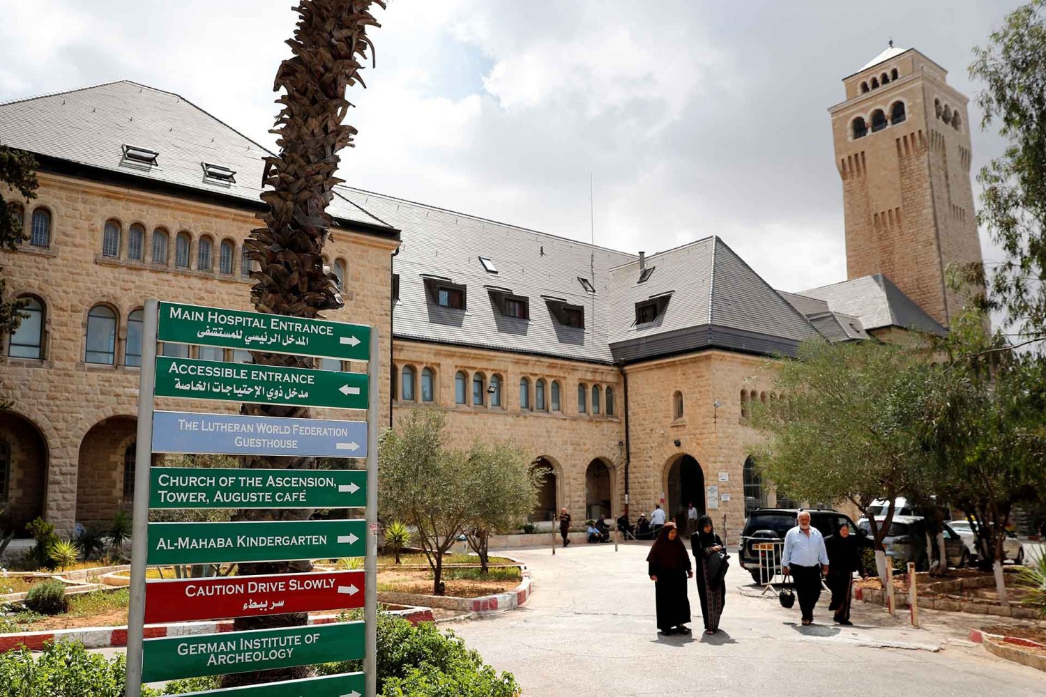 People walk outside of the Augusta Victoria hospital in East Jerusalem on September 9, 2018. 