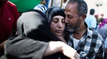 A released Palestinian prisoner hugs relatives, October 18, 2011, Ramallah, West Bank.