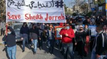 Palestinian, Israeli, and foreign activists demonstrate in Sheikh Jarrah, March 19, 2021.