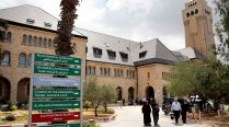 People walk outside of the Augusta Victoria hospital in East Jerusalem on September 9, 2018. 