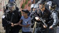 Israeli riot policemen arrest a Palestinian boy in East Jerusalem.