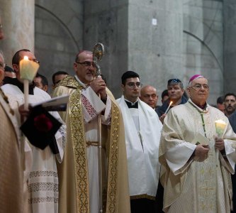 Pierbattista Pizzaballa stands with clergy and worshippers on Easter at the Church of the Holy Sepulchre, Jerusalem, March 31, 2024.