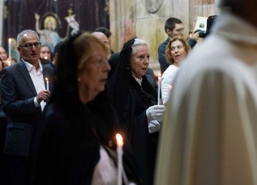 Worshippers sing hymns while holding candles on Easter at the Church of the Holy Sepulchre, March 31, 2024.