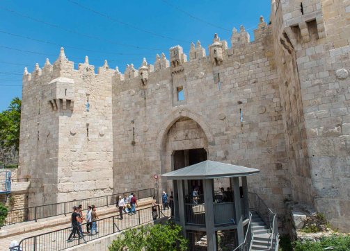 Tourists and locals pass through Damascus Gate in Jerusalem  under the watch of a new police guard tower, May 15, 2018