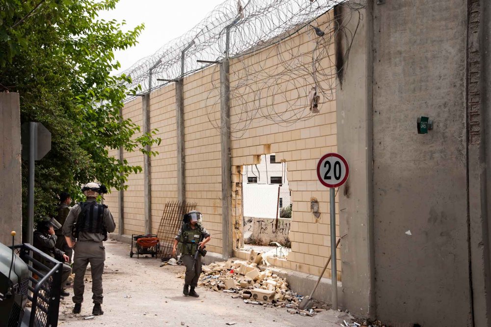 Israeli soldiers patrol the Separation Wall where Palestinian protesters broke through it, May 19, 2013