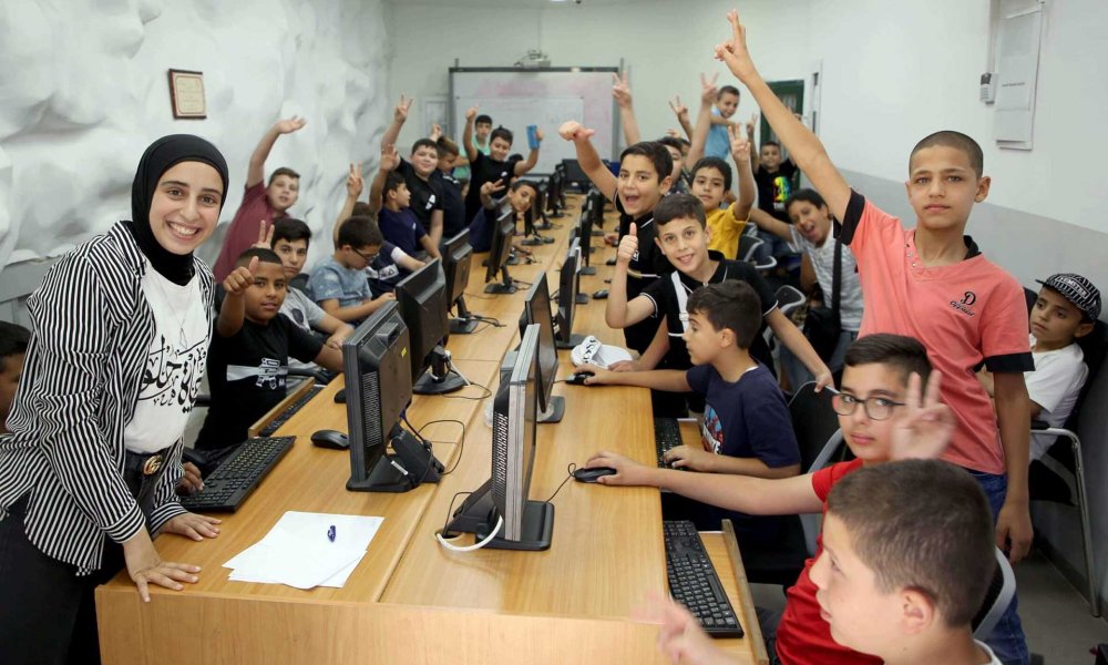 Youth excited about learning on computers at Burj al-Luqluq Society in Jerusalem’s Old City