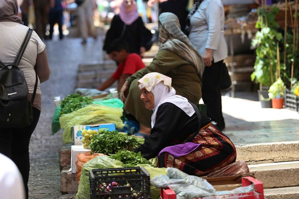 A Palestinian villager sells herbs inside Damascus Gate, June 2021.