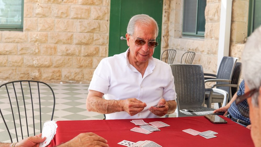 Senior members of the East Jerusalem YMCA play cards, May 21, 2024.