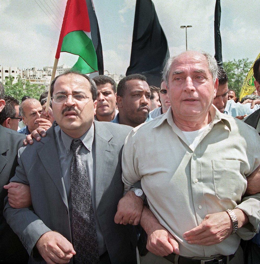 MK Ahmad Tibi and Faisal Husseini walk hand in hand to commemorate the Nakba at the al-Ram checkpoint, May 15, 2001.