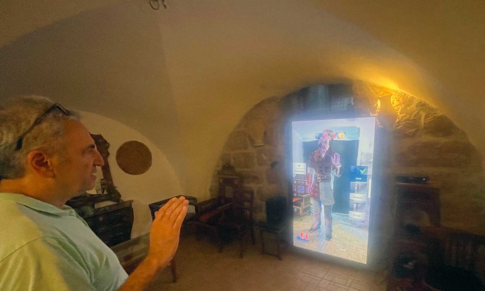 Raed Saadeh demonstrates how the augmented reality mirror works by selecting to view himself in Ayyubid (left) and more contemporary Palestinian costumes (right).