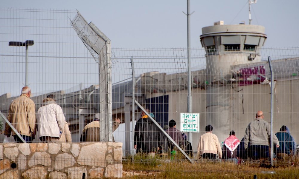 Palestinians wait to pass through Checkpoint 300, March 20, 2012.