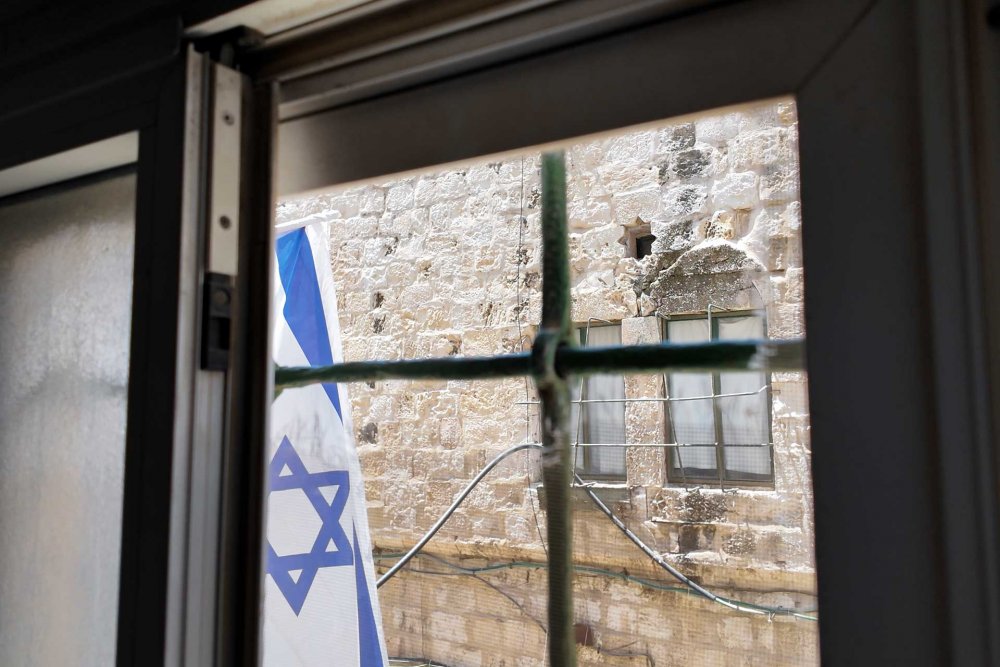 Palestinian home faces Israeli settler flag right outside its window in Jerusalem