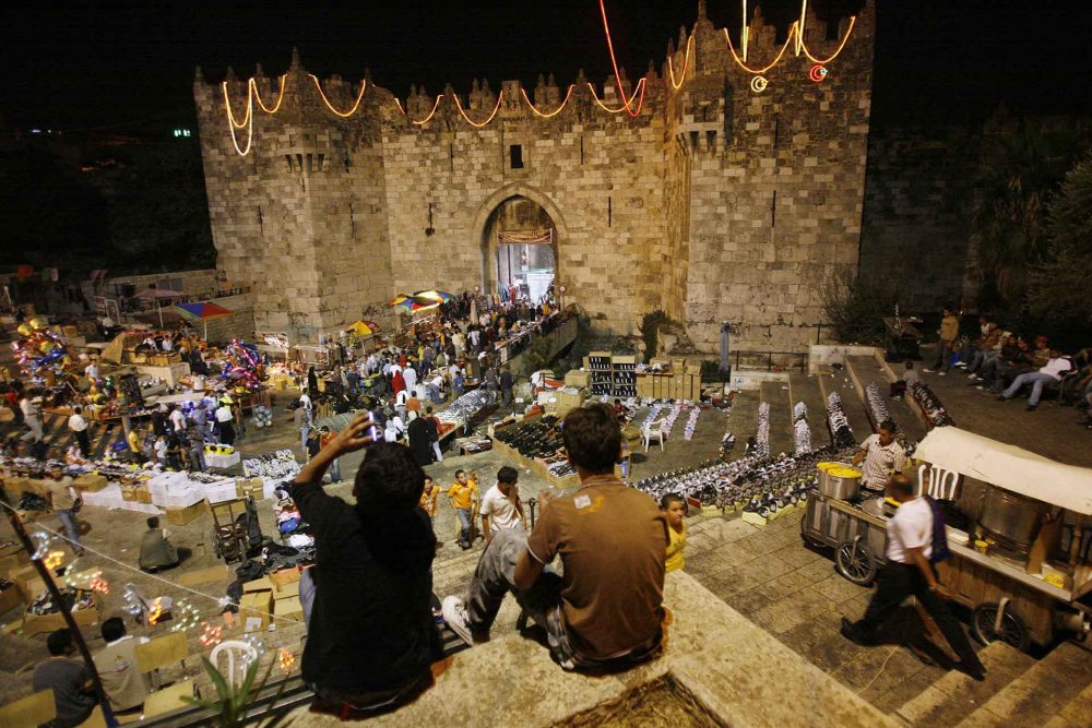 Palestinian boys watch shoppers at Damascus Gate in Jerusalem’s Old City, October 8, 2007.