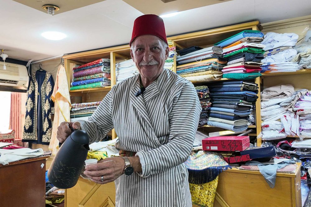 Bilal Abu Khalaf pours coffee in his shop in Jerusalem, July 22, 2024.