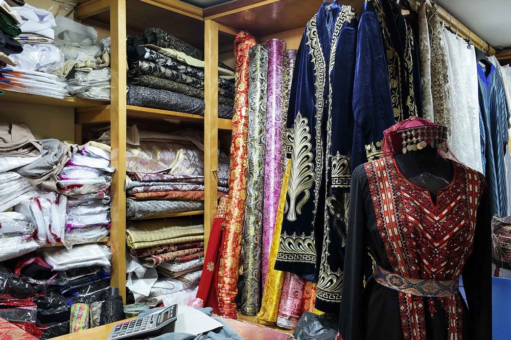 Shelves of fabrics in Bilal Abu Khalaf's shop in Jerusalem's Old City, July 22, 2024