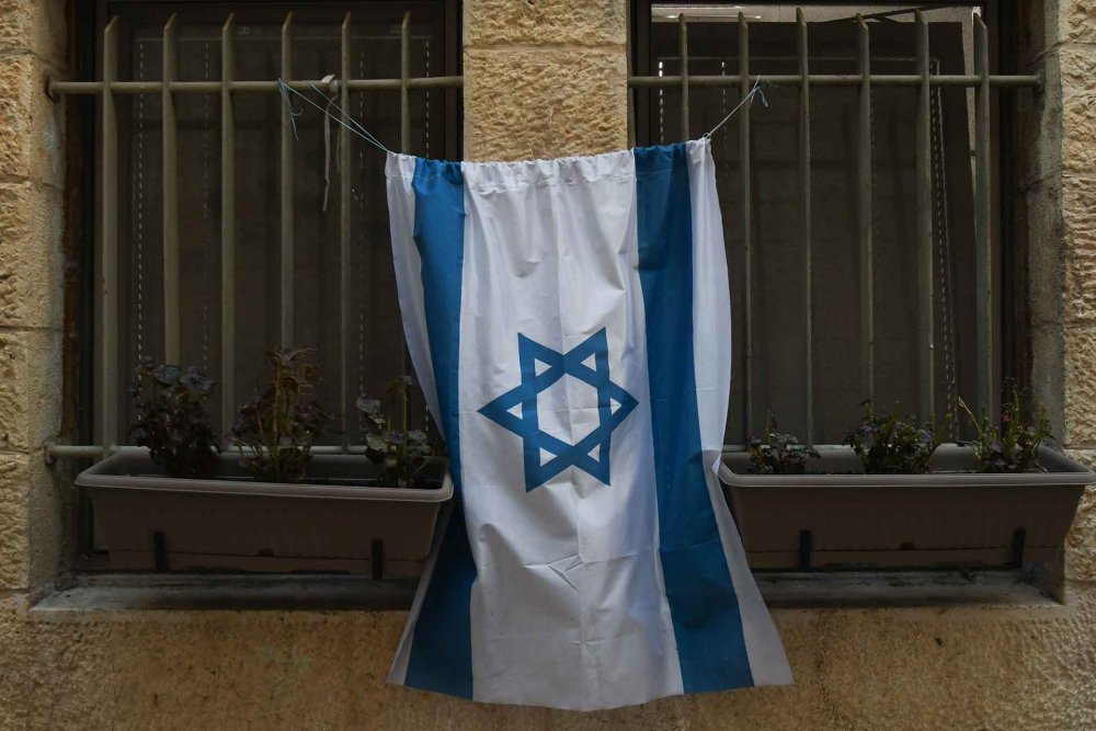 An Israeli flag on the barred windows of a home in Jerusalem's Old City, February 28, 2020