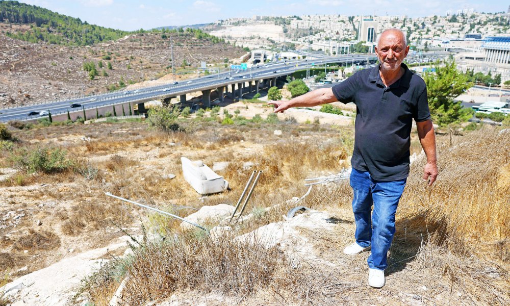 A Beit Safafa resident shows land where Israel plans to build settlement of Givat Shaked, East Jerusalem, September 2022.