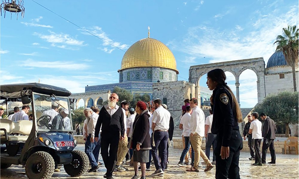 Israeli settlers stage provocative raid on the al-Aqsa Mosque compound, guarded by Israeli police.