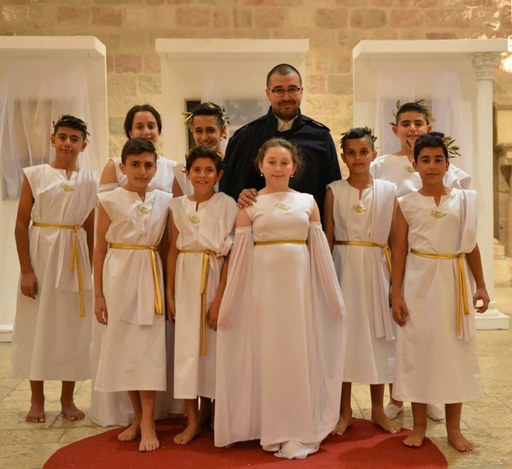 Ahmad Nabil and the children who form The Fiction Council, dressed to assume roles in a fantastical enactment, April 2018