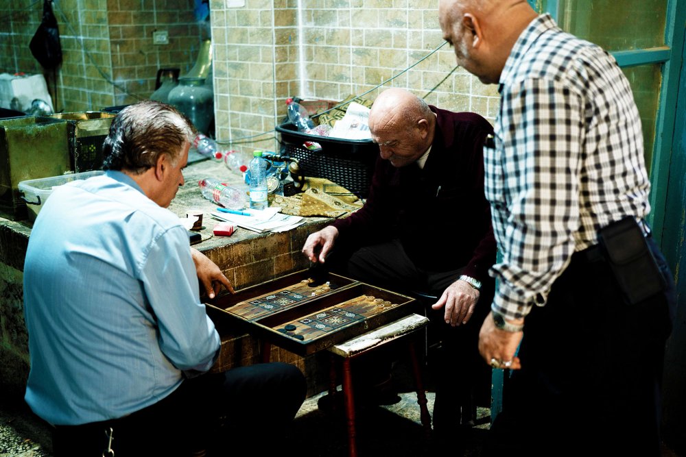 Bored Palestinian shopkeepers in the Old City of Jerusalem pass time by playing backgammon as tourism has evaporated.