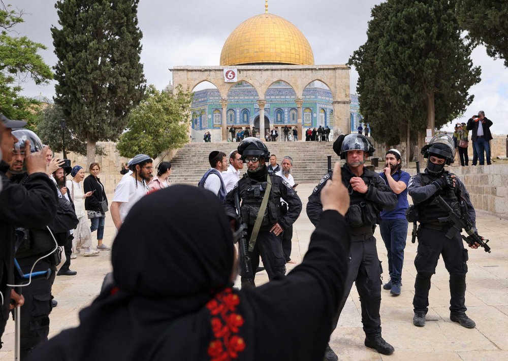 Israeli police accompany a group of Jewish visitors through al-Haram-al-Sharif, May 5, 2022