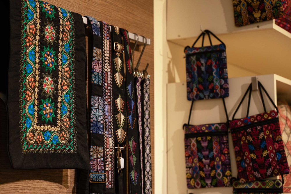 Palestinian-designed tote bags and headbands displayed at Sunbula, Jerusalem, August 21, 2024