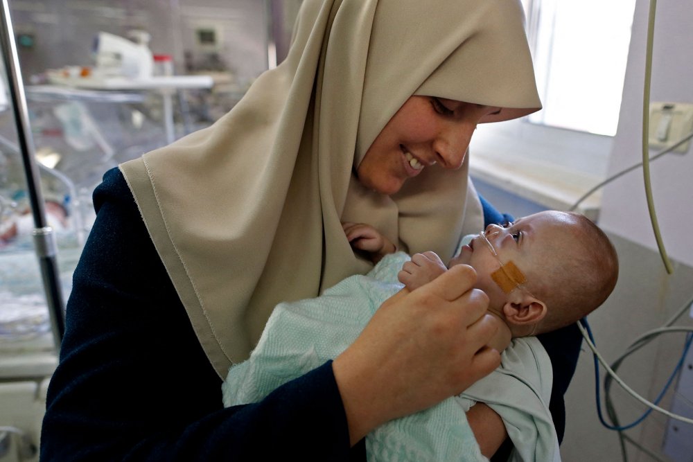 A Palestinian from Gaza reunites with her seven-month-old baby, born prematurely at Makassed Hospital, Jerusalem, February 20, 2017.