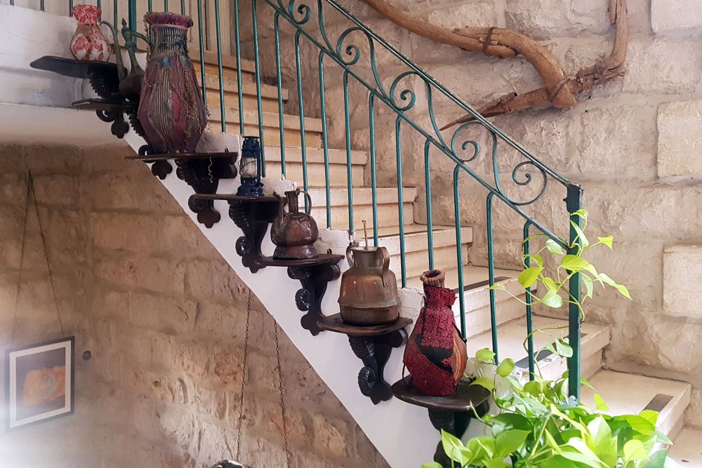 Cultural artifacts displayed along an internal staircase at the Jerusalem Hotel, Jerusalem