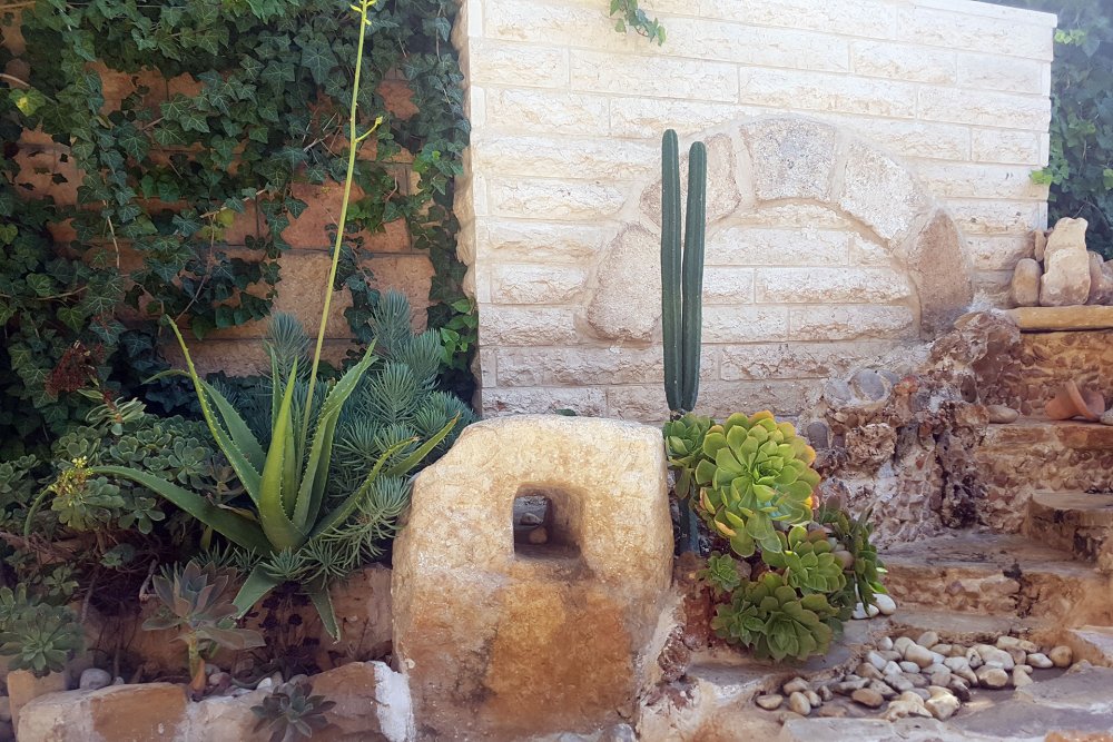 An olive press millstone in the front garden of the Jerusalem Hotel, East Jerusalem, September 11, 2024