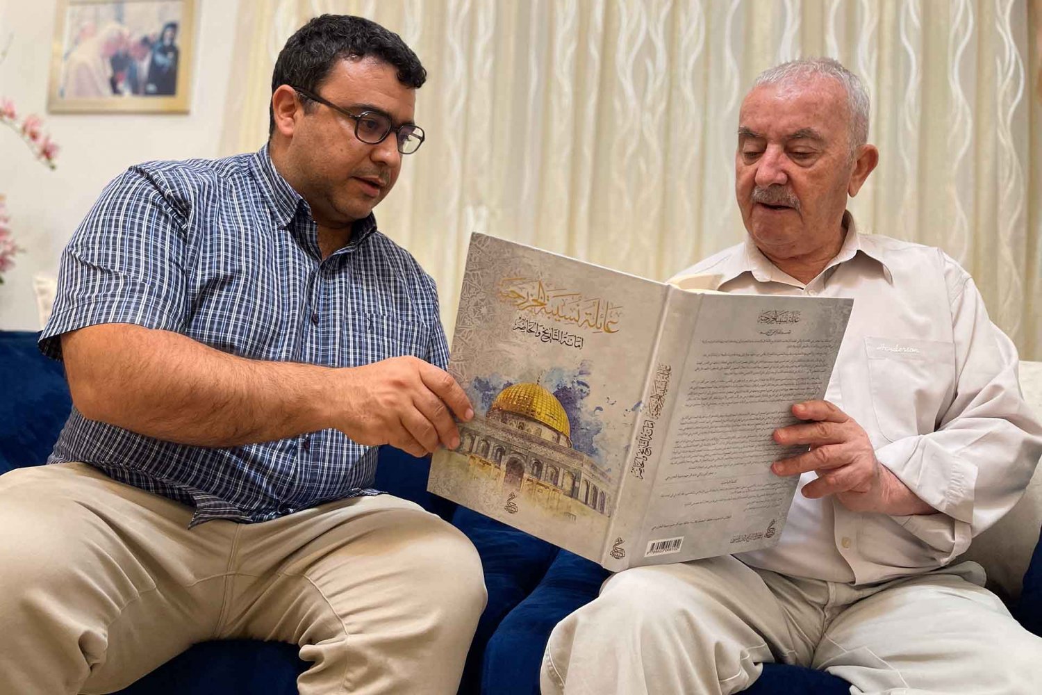 Wajih and Munir Nusseibeh hold the Nusseibeh family book, The Khazraj Nusseibeh Family: Custodians of History and the Present